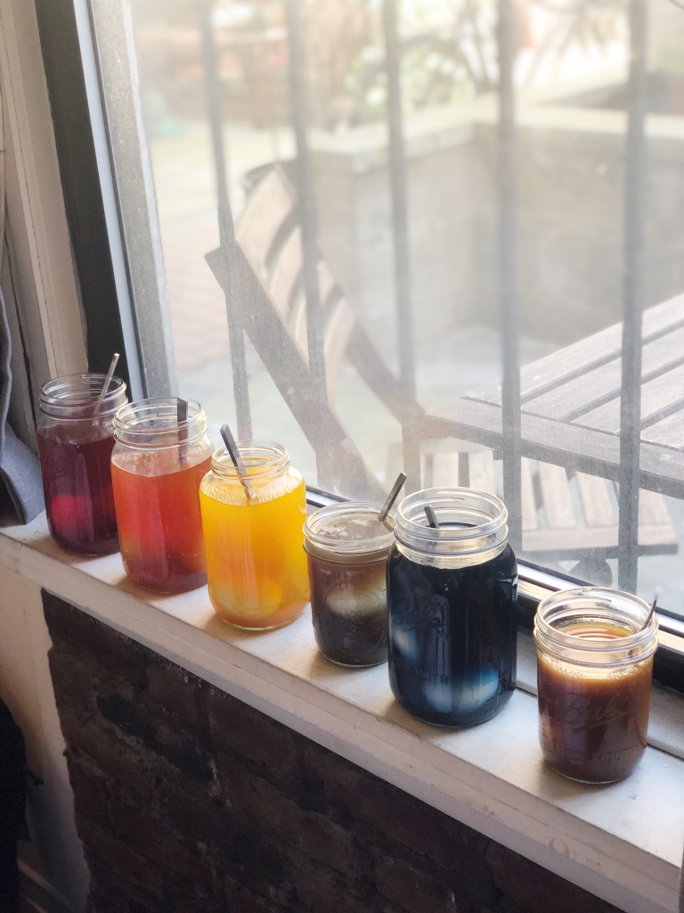 Glass jars of natural Easter egg dye sitting on a windowsill